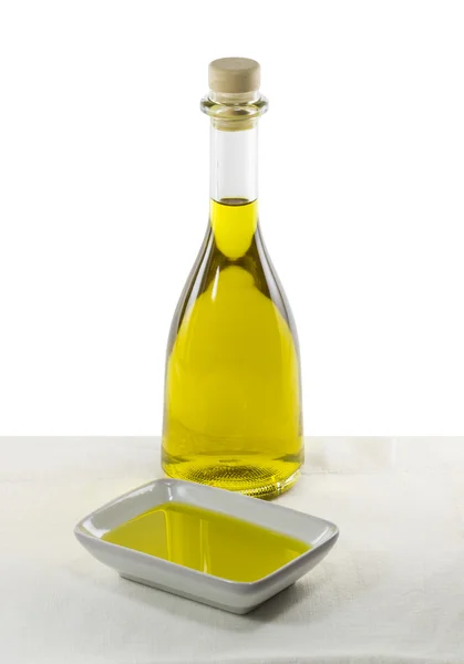 Olive oil in glass bottle and dish — Stock Photo, Image