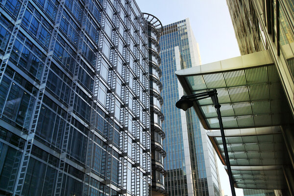 LONDON, CANARY WHARF UK - APRIL 13, 2014 - Modern glass architecture of Canary Wharf business aria, headquarters for banks, insurance, media and other world known companies