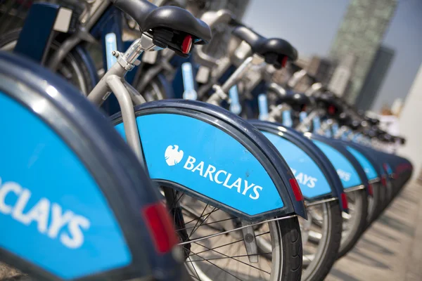 LONDON, UK - MAY 7, 2014: Boris bikes parking on business Canary Wharf aria, sponsored by Barkley's bank. Popular city transport among Londoners