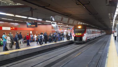 MADRID, SPAIN - MAY 28, 2014: Madrid tube station, train arriving on a platform clipart