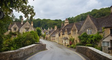 WILTSHIRE, CHIPPENHAM, UK - AUGUST 9, 2014: Castle Combe, unique old English village and luxury golf club clipart