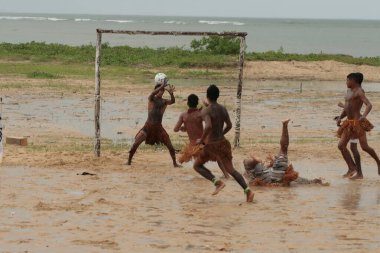 santa cruz cabralia, bahia, brazil - april 20, 2009: Indigenous people of the Pataxo ethnicity playing a football match during the Indigenous Games of the Coroa Vermelha village. clipart