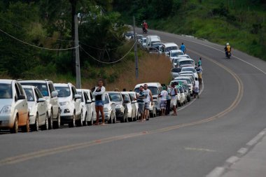 itaparica, bahia, brazil - june 24, 2014: vehicles queued to access the Ferry Boat system on the island of Itaparica bound for the city of Salvador. clipart