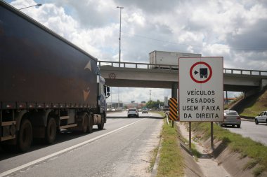 Salvador, Bahia, Brezilya - 11 Nisan 2022: trafik levhası ağır araçların Salvador şehrindeki BR 324 otobanındaki sağ şeridi kullanacağını gösteriyor..