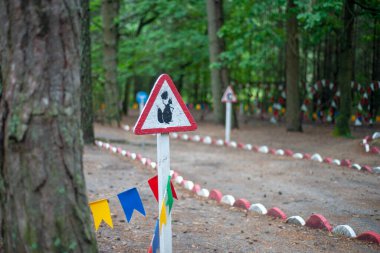 The sign is on a forest kart car - the squirrel with a pine cone.