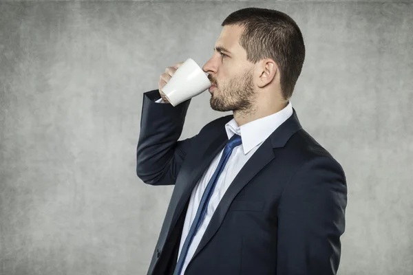 Businessman drinking coffee to the bottom — Stock Photo, Image