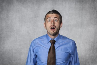 Surprised businessman looking in disbelief