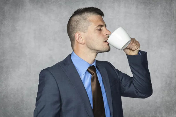 Funny businessman drinking coffee — Stock Photo, Image