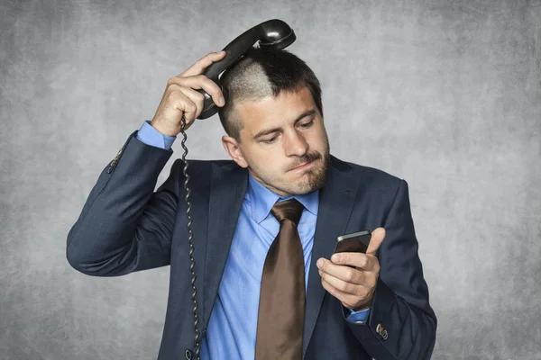 Businessman with a funny haircut can not handle phone Stock Photo