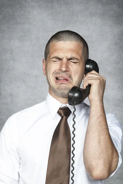 Businessman crying while talking on the phone — Stock Photo, Image