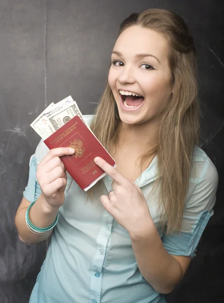 Portrait of cute girl student with money and passport