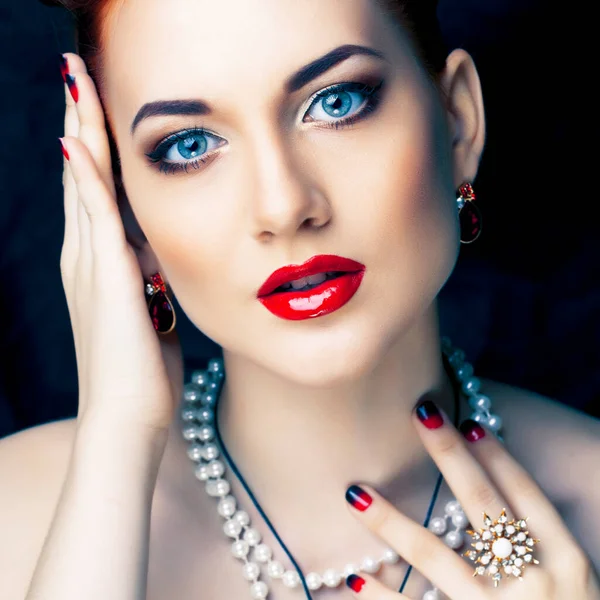 beauty rich woman with bright makeup wearing luxury jewellery on black background, fashion lady