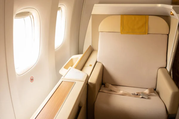 Luxury first class or business class suite on airplane in gold color feel private for travel.Business comfort and eleglance chair when fly with airline.