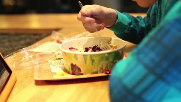 Menino comendo salada no restaurante fast food — Vídeo de Stock