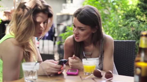 Girlfriends with smartphone in cafe — Stock Video
