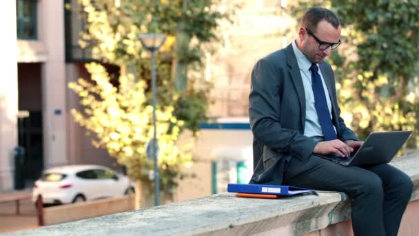 Businessman working on documents and laptop — Stock Video