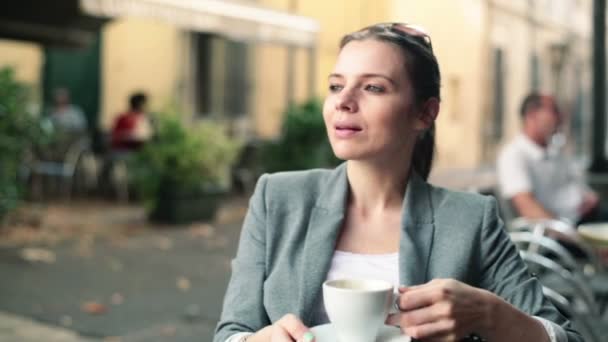 Pretty businesswoman drinking coffee — Stock Video