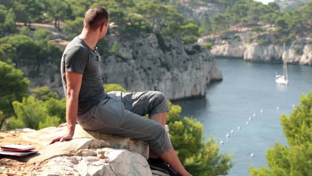 Homme relaxant sur la falaise — Video