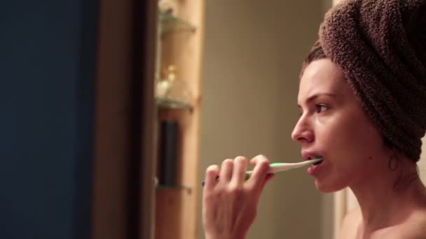 Жінка чистить зуби зубною щіткою — стокове відео