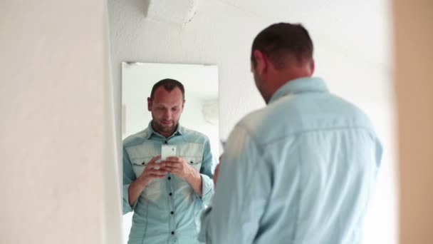 Man taking photo of himself in mirror — Stock Video