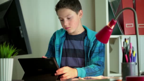 Boy doing homework with tablet computer — Stock Video