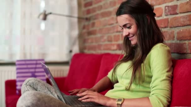 Vrouw met moderne laptop op sofa — Stockvideo