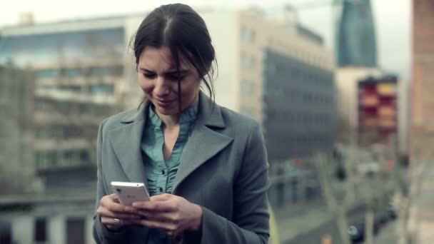 Businesswoman using smartphone on terrace — Stock Video