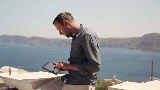 Man with tablet computer on terrace — Stock Video