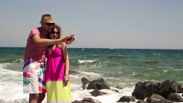 Couple taking photo with cellphone by the sea — Stock Video