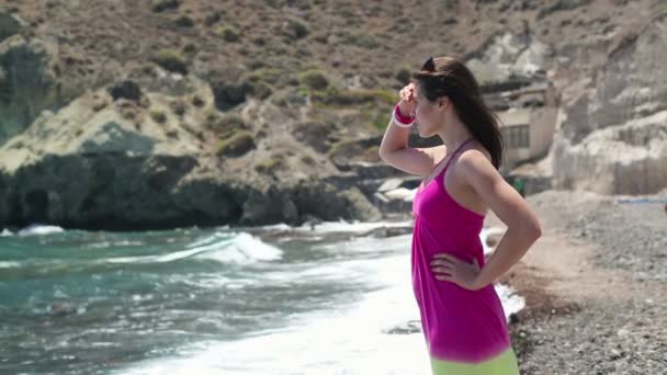 Beautiful woman standing by the sea — Stock Video