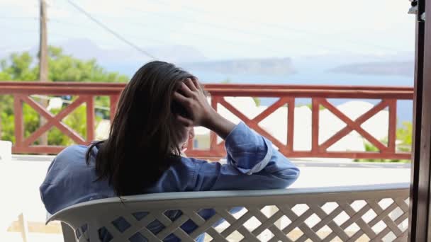 Sad woman sitting on terrace — Stock Video