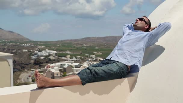 Young man relaxing on terrace — Stock Video