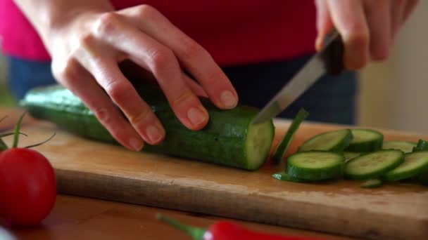 Slicing cucumber on chopping board — Stock Video