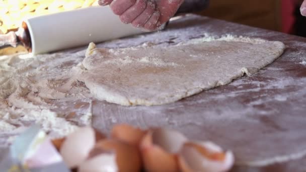 Hand sprinkling flour on dough — Stock Video