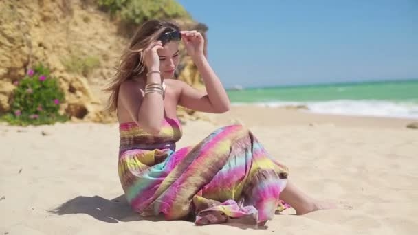 Mujer sentada en la playa — Vídeo de stock