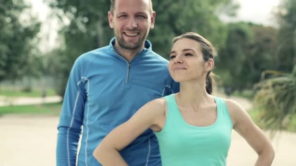 Běžci pár stojící v parku — Stock video