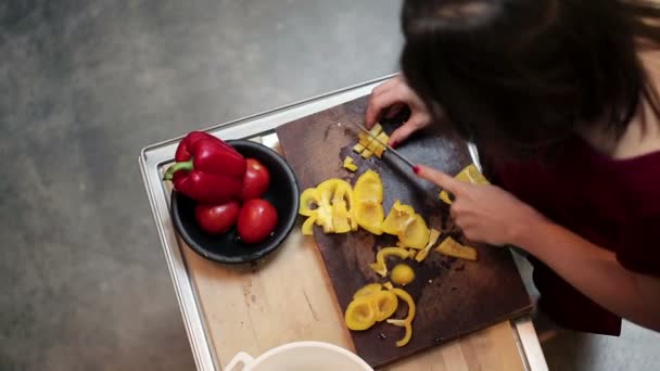 Woman slicing yellow pepper — Stock Video