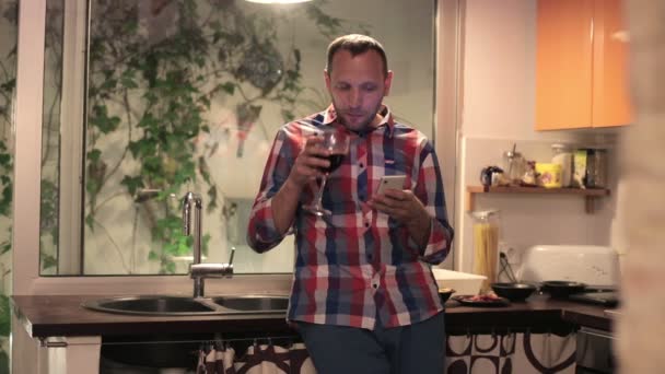 Man drinking wine and texting on smartphone — Stock Video