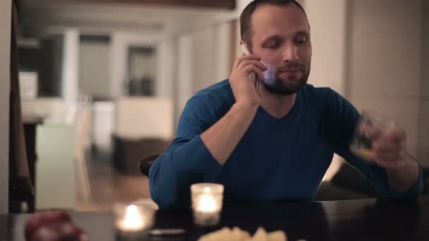 Man äter och talar på mobiltelefon — Stockvideo