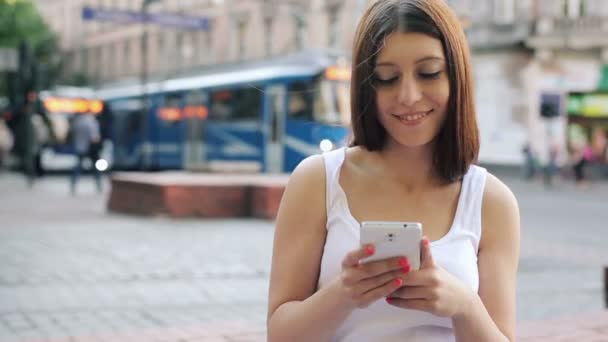 Mulher mensagens de texto no smartphone na cidade — Vídeo de Stock