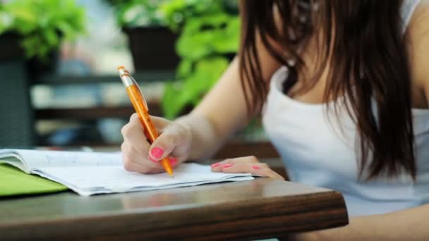 Student doing homework in cafe — Stock Video