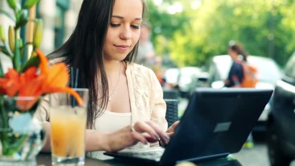 Mulher digitando no laptop no café — Vídeo de Stock