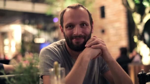 Happy young man sitting in cafe — Stock Video