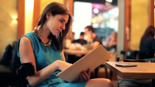 Menú de lectura mujer en restaurante — Vídeo de stock