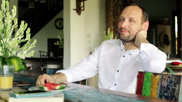 Man relaxing by the table at home — Stock Video