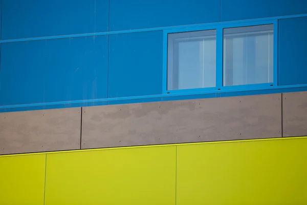 Modern office buildings. Colorful buildings in a industrial place. Blue and yellow windows. — Stock Photo, Image