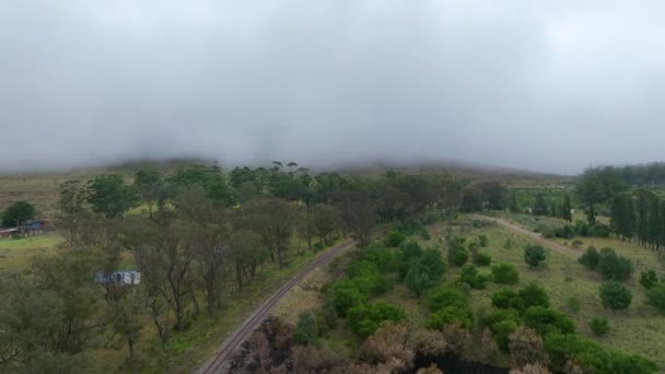 Drone survolant une ligne de chemin de fer avec fond couvert de brouillard — Video