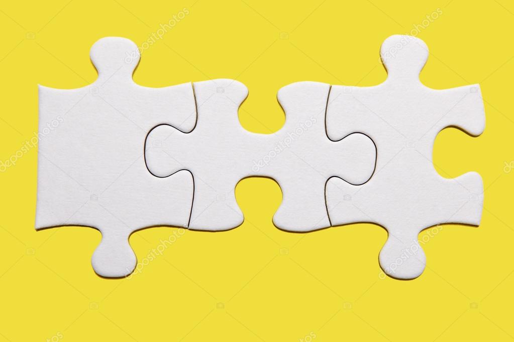 Three puzzle pieces on yellow