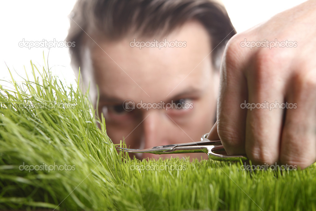 Young man cuts English lawn
