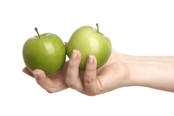 Vrouwelijke hand met twee groene appels — Stockfoto